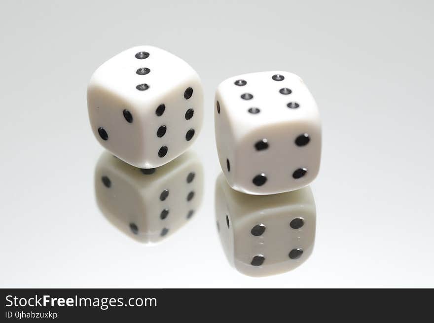 Pair of White Dice on Top of Mirror