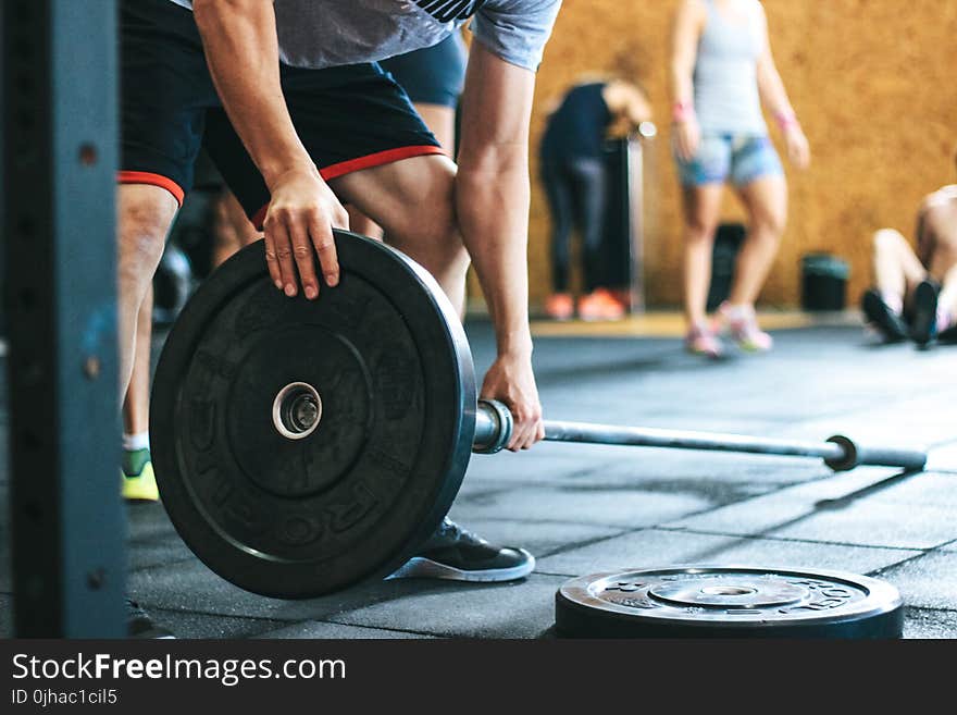 Man Holding Black Barbell