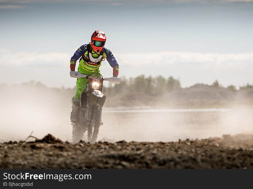 Person In Green Motocross Gear Riding A Dirt Bike