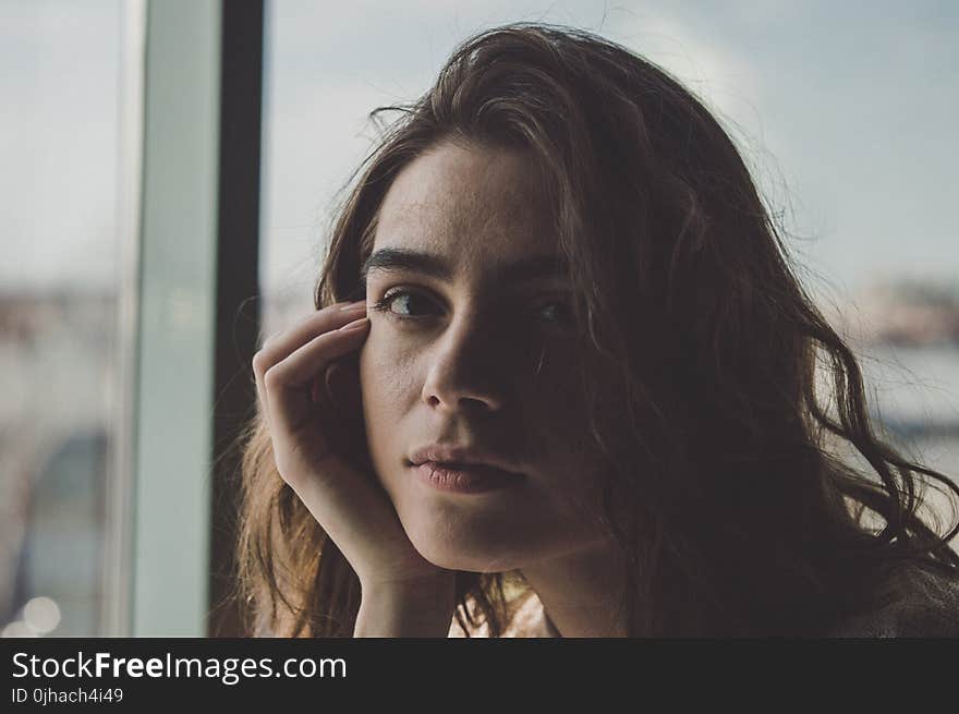 Woman in Room Near Glass Window