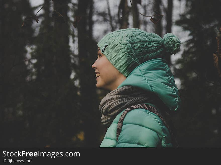 Low Light Photo of Person Wearing Green Jacket and Hat