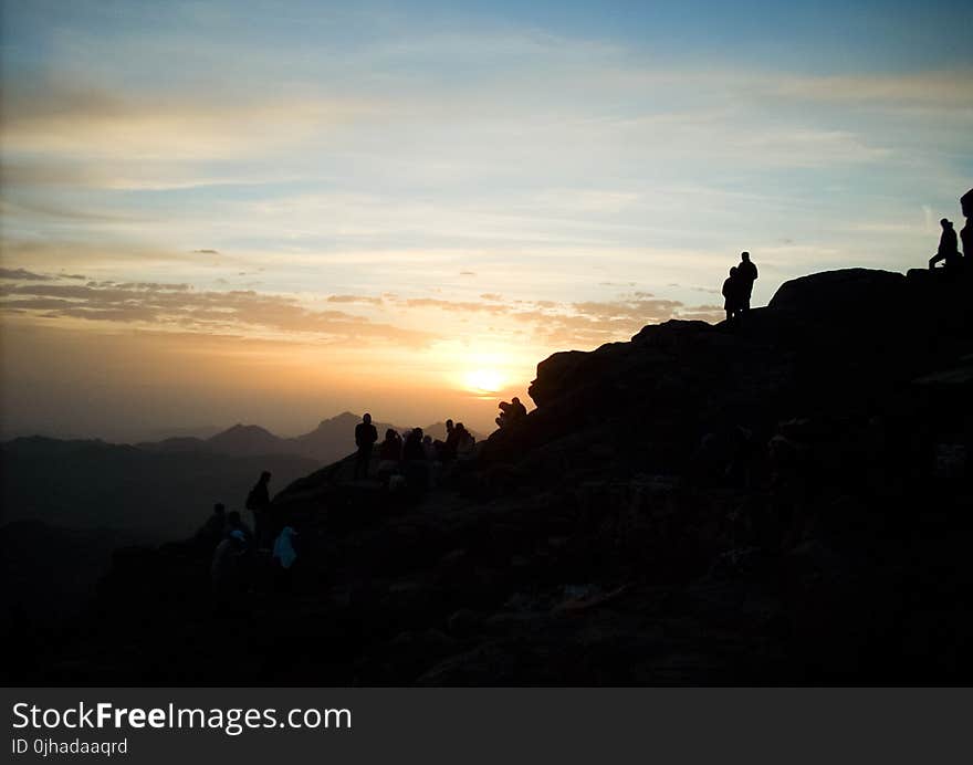 Silhouette of Group of Person Hiking on the Mountain