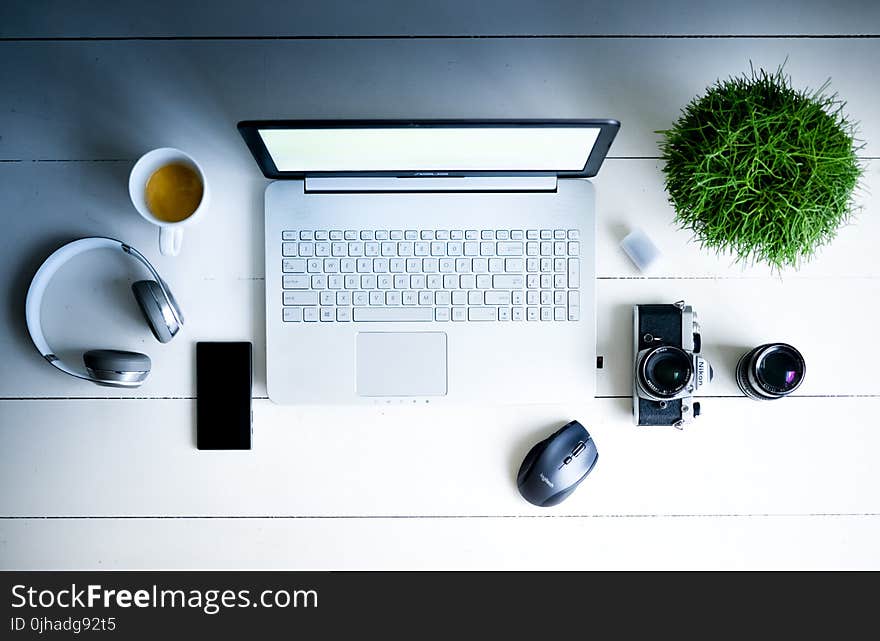 Photography of Laptop Computer, Camera, Smartphone, Headphones, And Mug