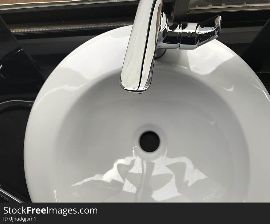 White Ceramic Sink With Stainless Steel Faucet