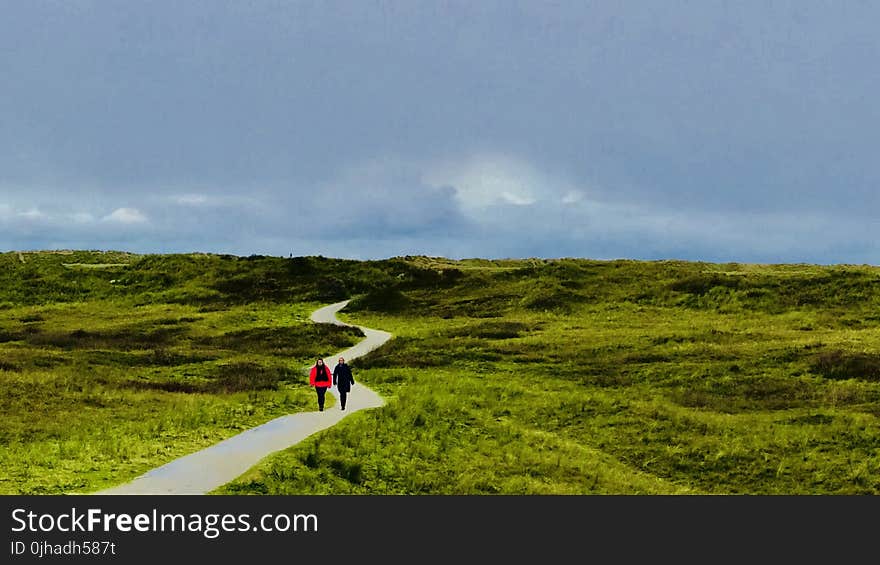 Two Person Walking On Path Under Blue Sky