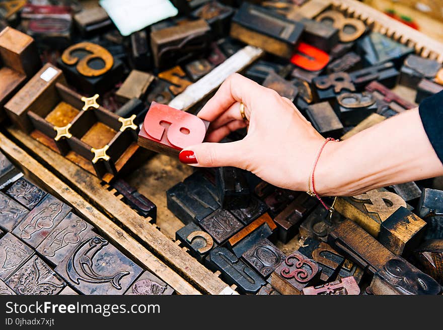 Person Holding Red Wooden Letter a Ornament