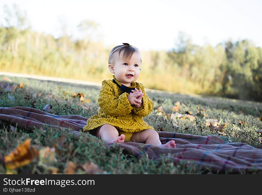 Baby Wearing Yellow Crochet Long Sleeve Dress Sitting on Brown Textile