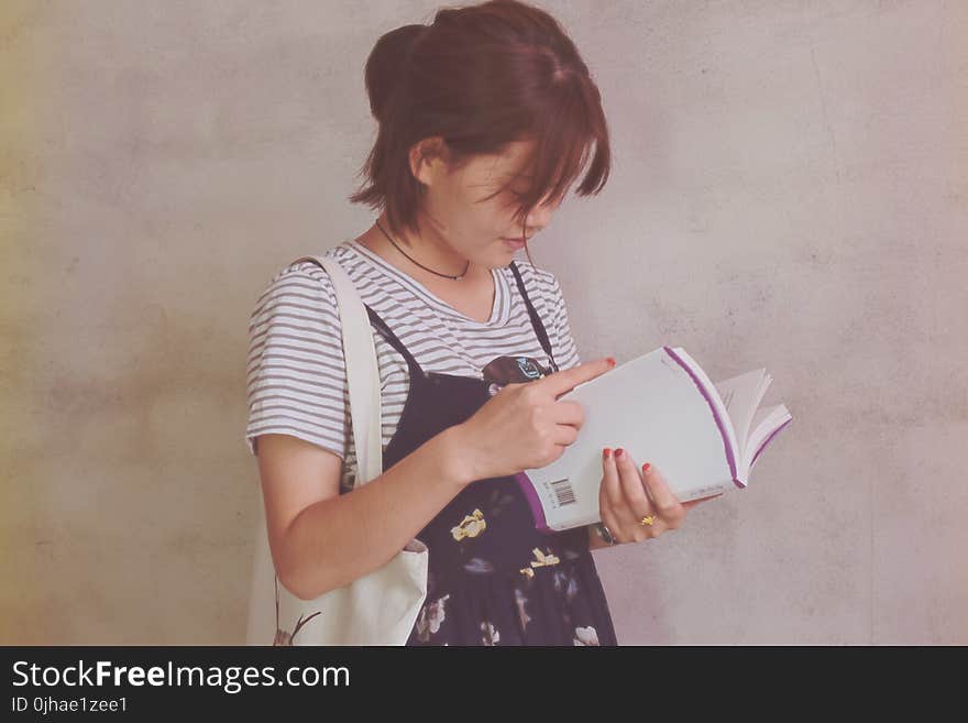 Woman Holding White Book