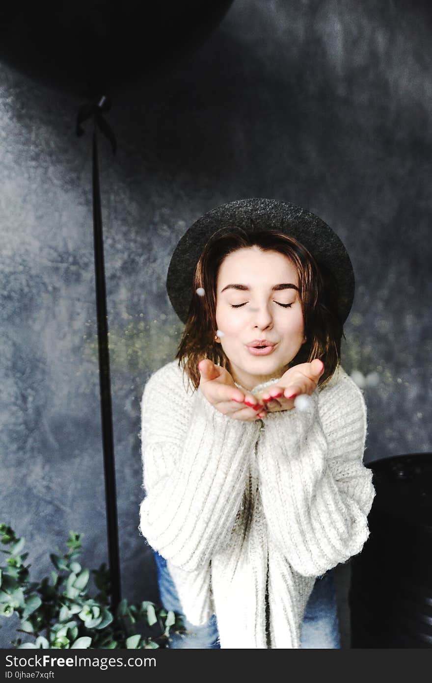 Female Wearing Hat Blowing Kisses