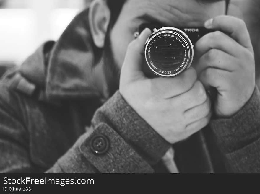 Man Taking Photo Using Black Dslr Camera