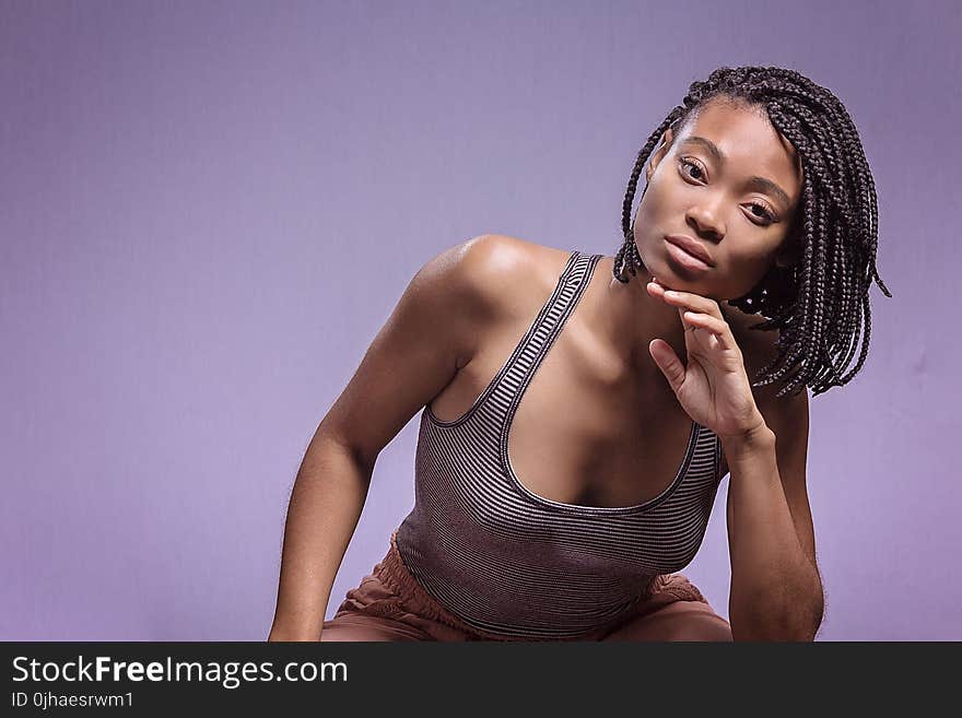 Woman in Black and White Tank Top Posing for Picture