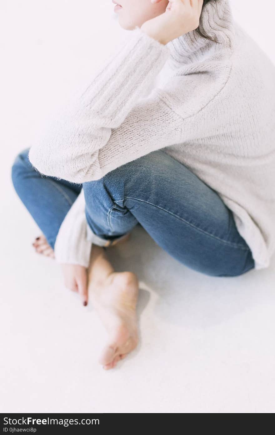 Woman in Gray Sweater and Blue Denim Jeans