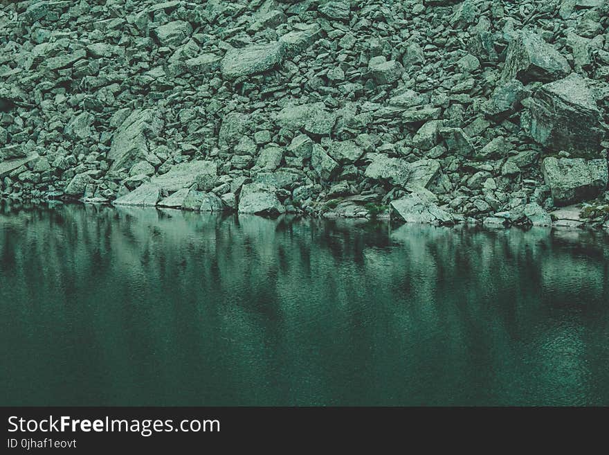 Rocks Near Calm Body Of Water