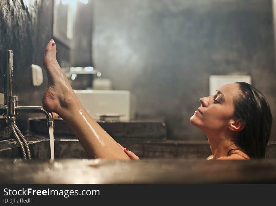 Woman on Gray Concrete Bath Tub