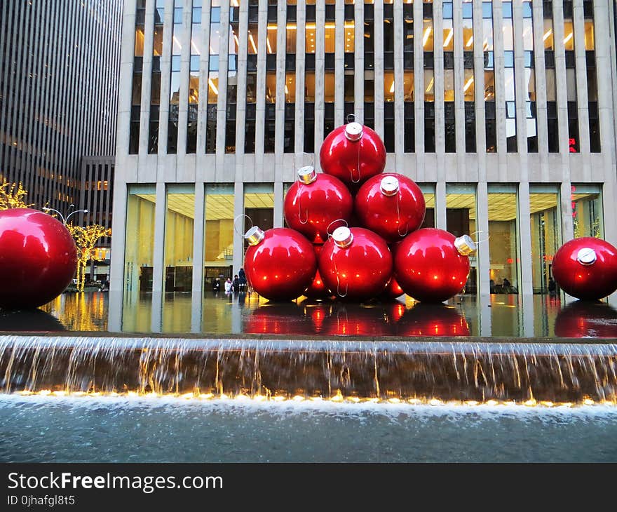 Red Baubles Near Grey High-rise Building