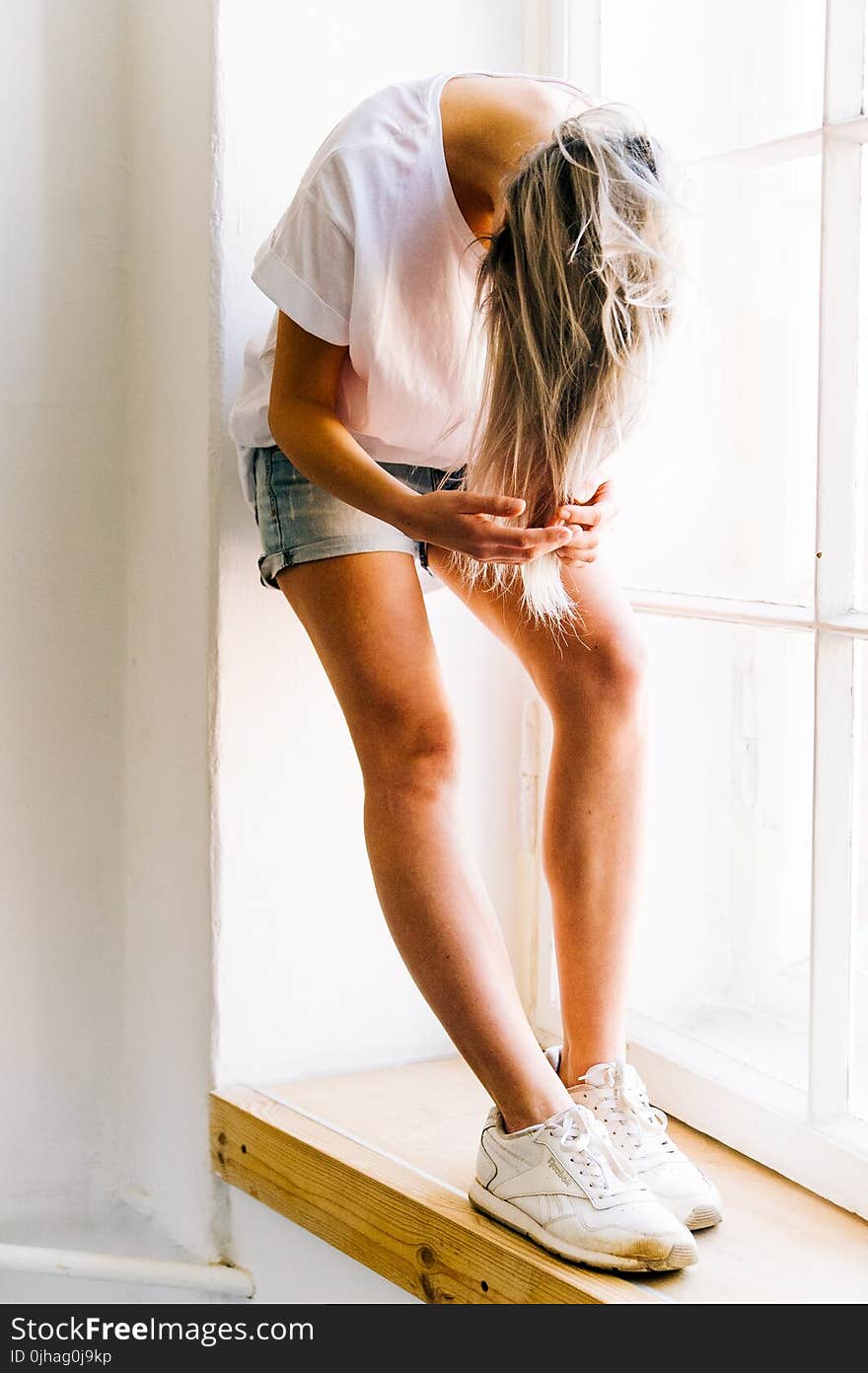 Woman in White T-shirt and Blue Denim Shot Shorts