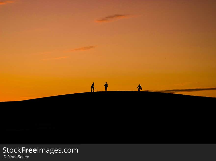 Silhouette of 3 People in Hill during Sunset