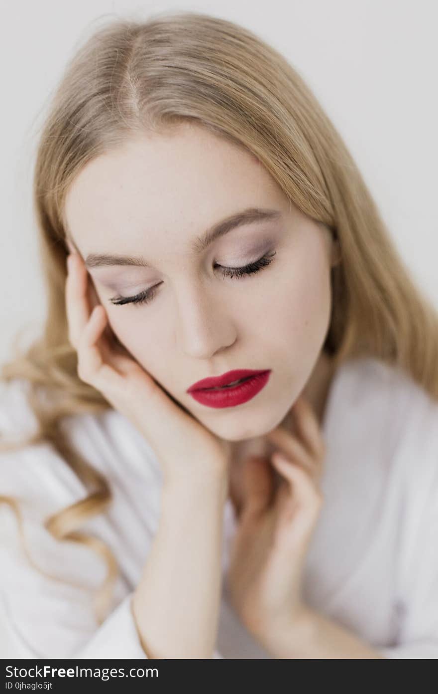 Close Up Photo of a Woman With Blonde Hair Wearing White Bathrobe