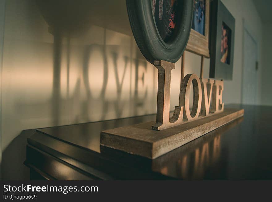 Brown Wooden Love Free Standing Letter on Black Wooden Surface