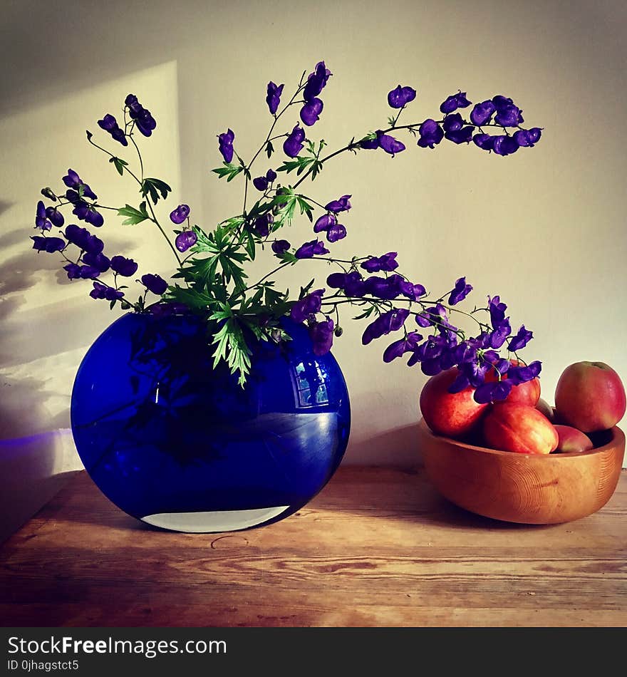 Purple Petaled Flower Arrangement Near Apple Fruit on Table