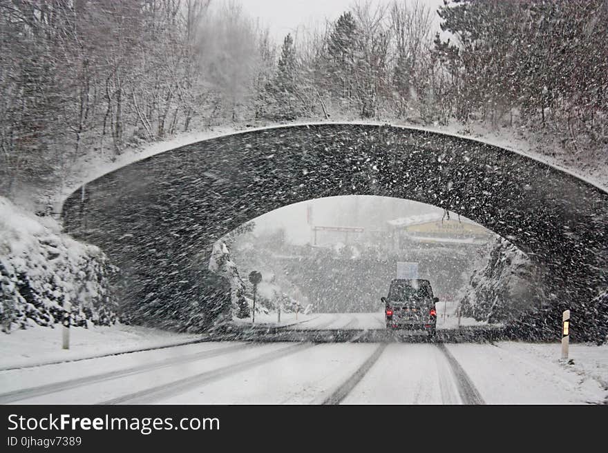 Photo of White Vehicle Crossing a Tunnel