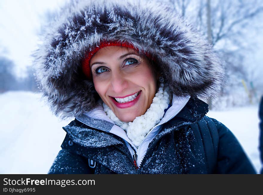 Close Up Photo of Woman Wearing Black Zip-up Parka Coat during Snow Season