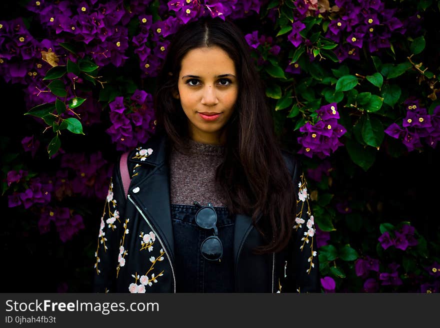 Woman Standing Near Purple Flowers