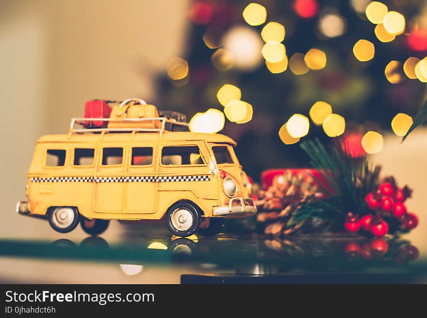 Selective Focus Photography of Yellow Vehicle Scale Model