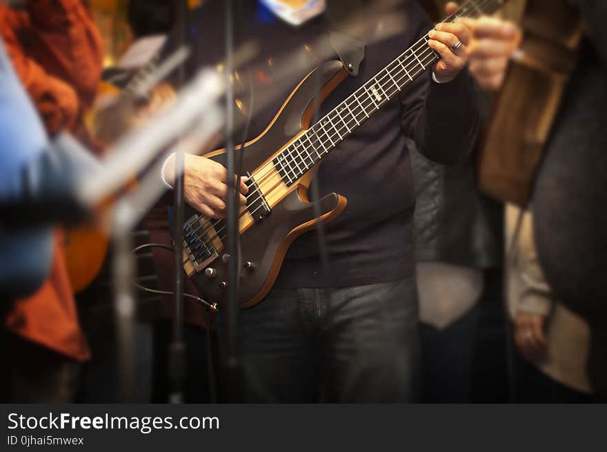 Man Holding Electric Bass Guitar