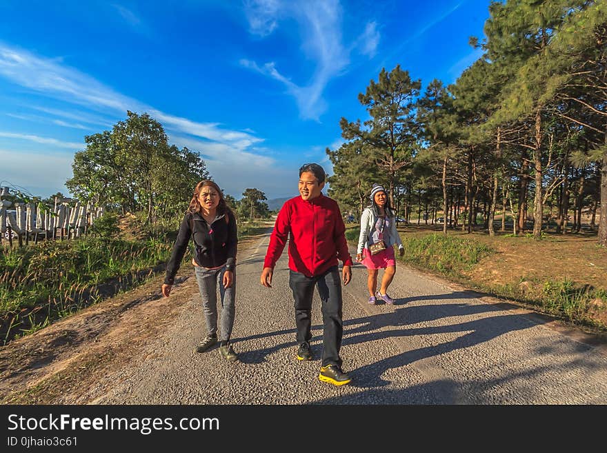 Man and Two Women Walking