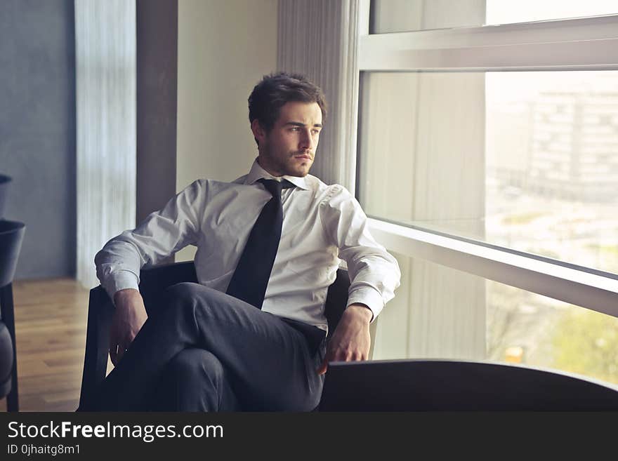 Man Wearing White Dress Shirt and Black Necktie