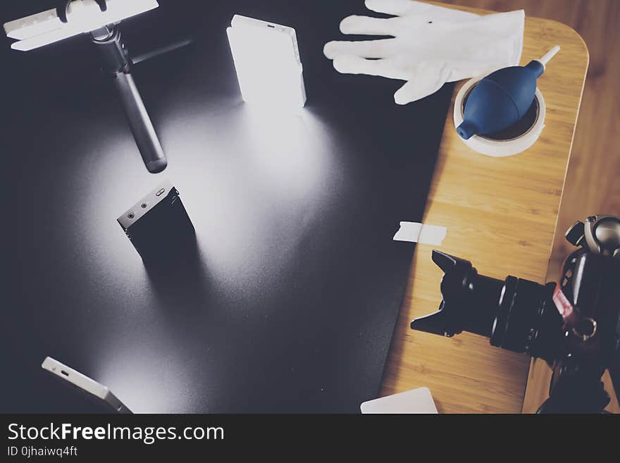 Black Dslr Camera on Top of Brown Wooden Table