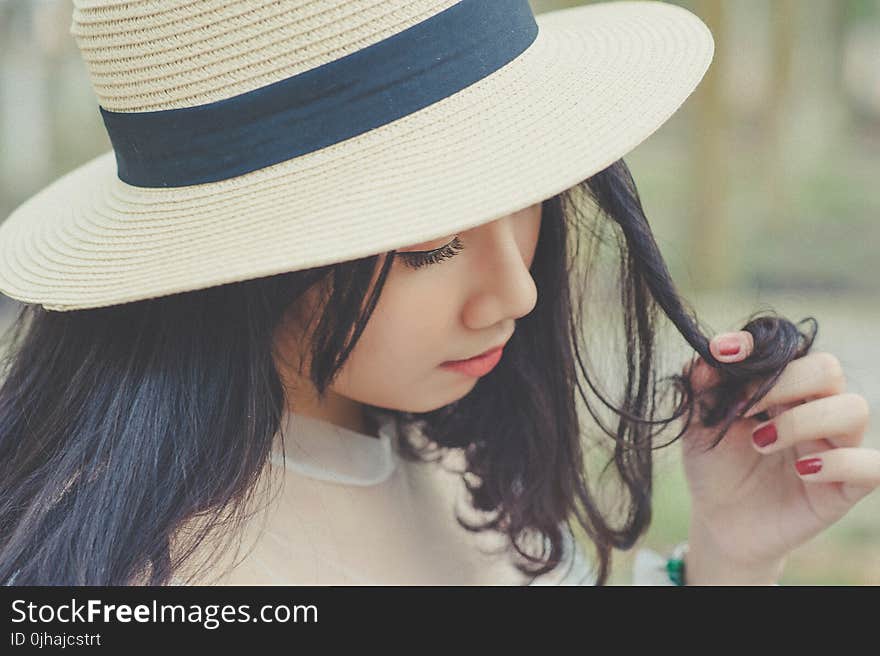 Selective Focus Photography of Woman With Brown Sun Hat