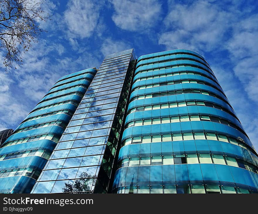 Low Angle Photography of Blue Tinted Glass Buildings