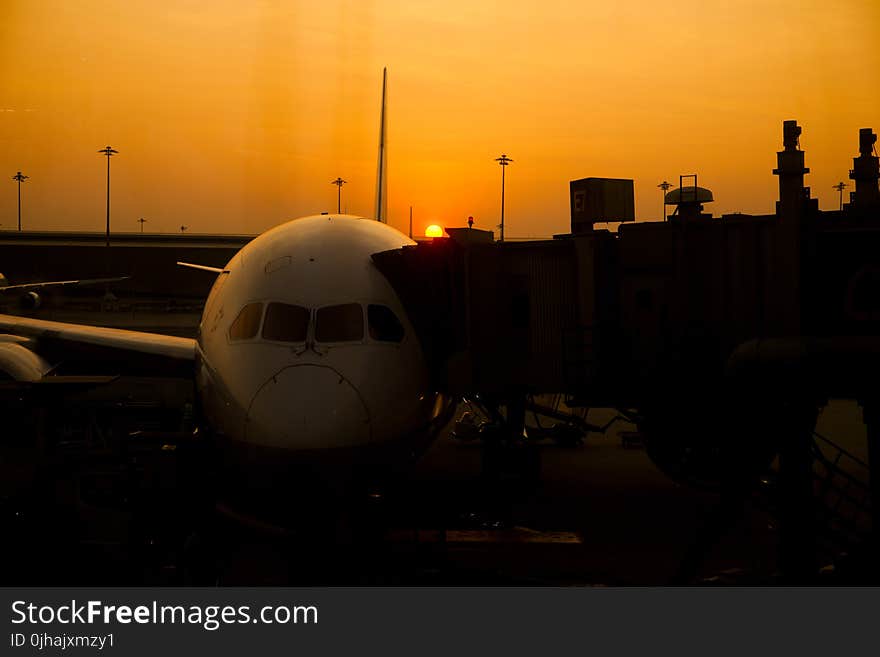 Silhouette of Airplane on Airport during Sunset