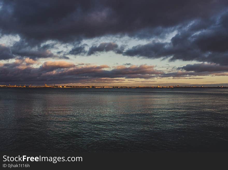 Body of Water during Purple Cloudy Sky