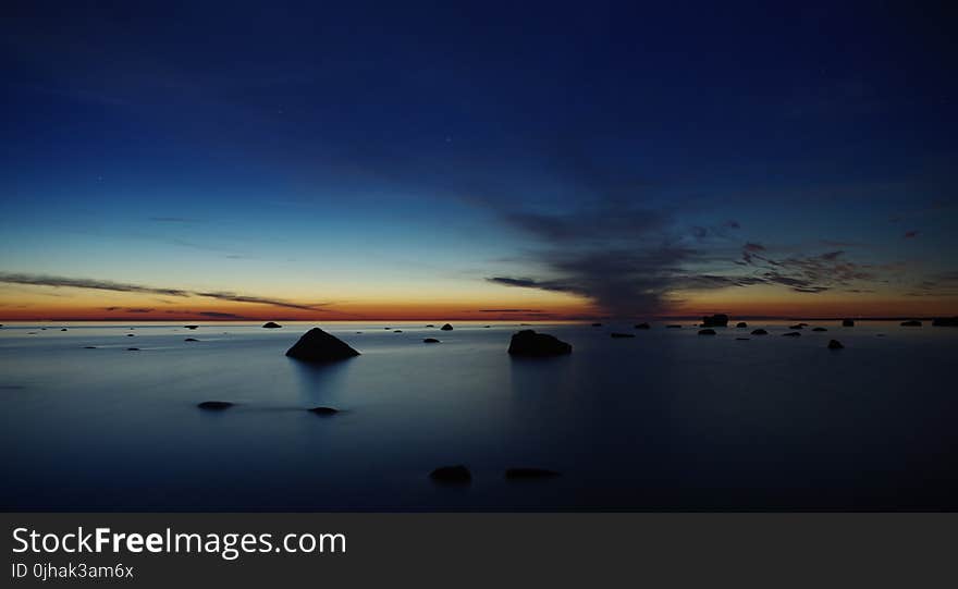 Body of Water Under Blue Skies during Golden Hour