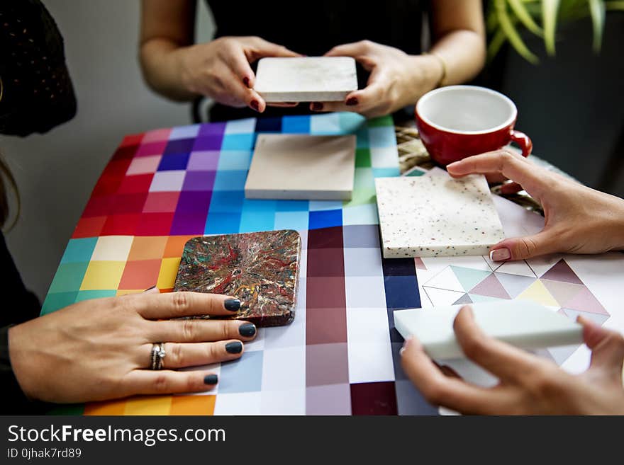 Shallow Focus Photography of Three People Holding Square Panels