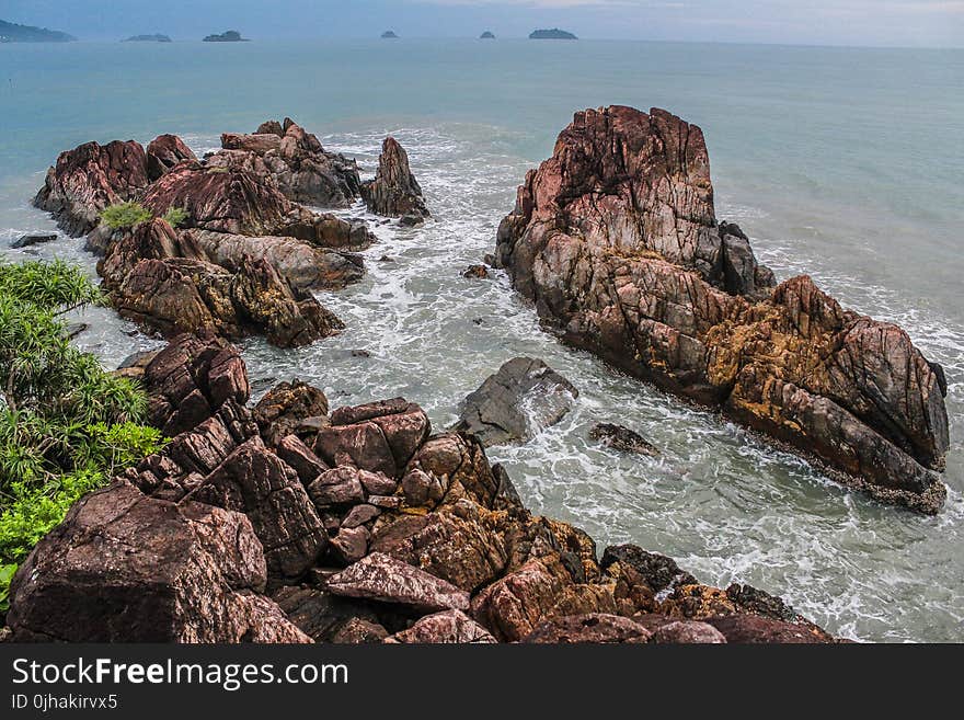 Brown Seashore Near Ocean at Daytime