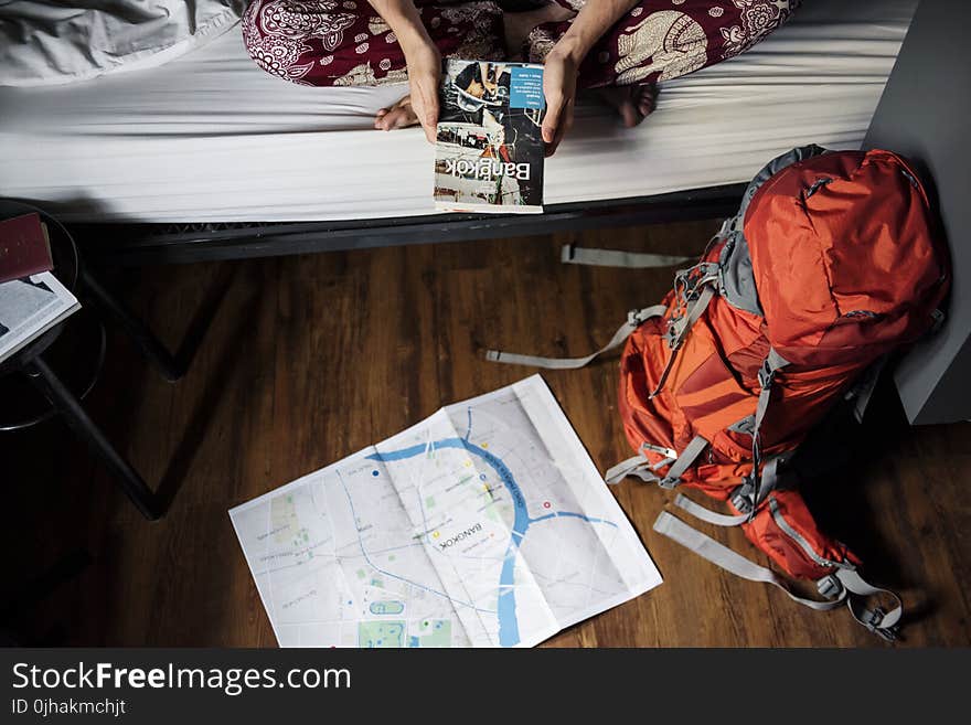 Orange and Gray Hiking Backpack on the Floor