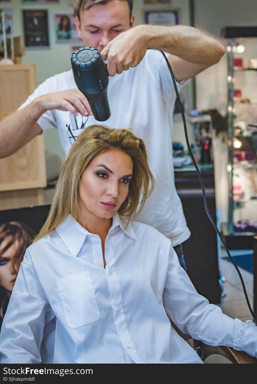 Man Drying Woman&#x27;s Hair