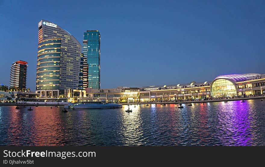 High-rise Building Near Body of Water during Night Time