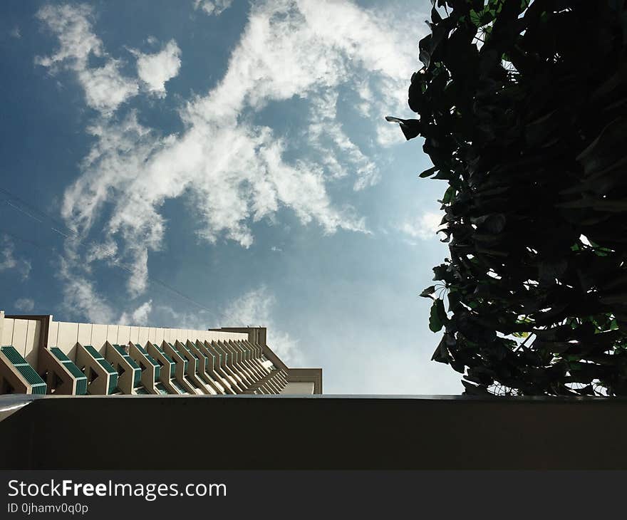 White Concrete Building With Cloudy Sky