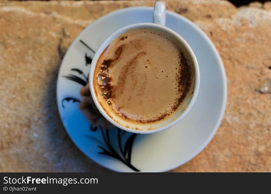 White Ceramic Mug With Coffee and White Ceramic Saucer