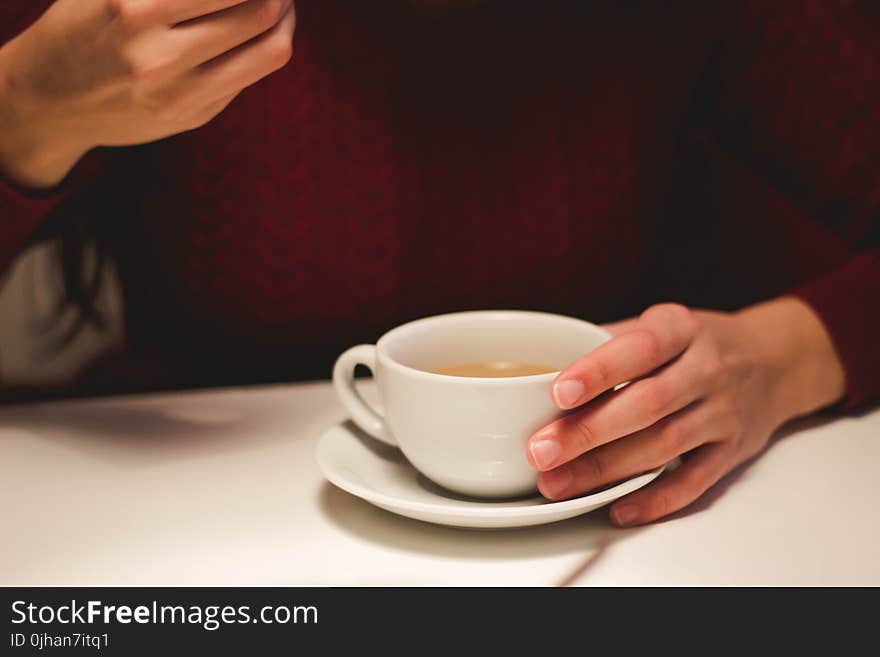 Person Holding White Ceramic Cup