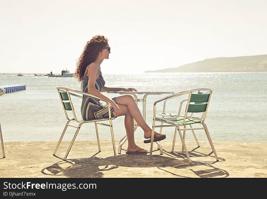 Woman Sitting on Armchair Near Seat