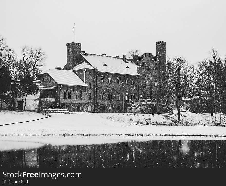 Greyscale Photo of Concrete House Covered With Snow