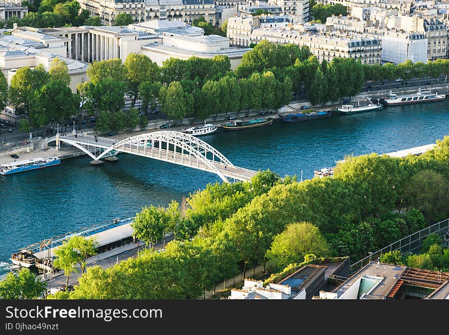 White Steel Bridge on Water Canal in the Middle of City during Day