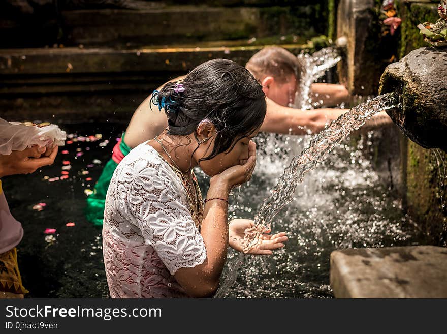 Man and Woman Bathing on Running Water