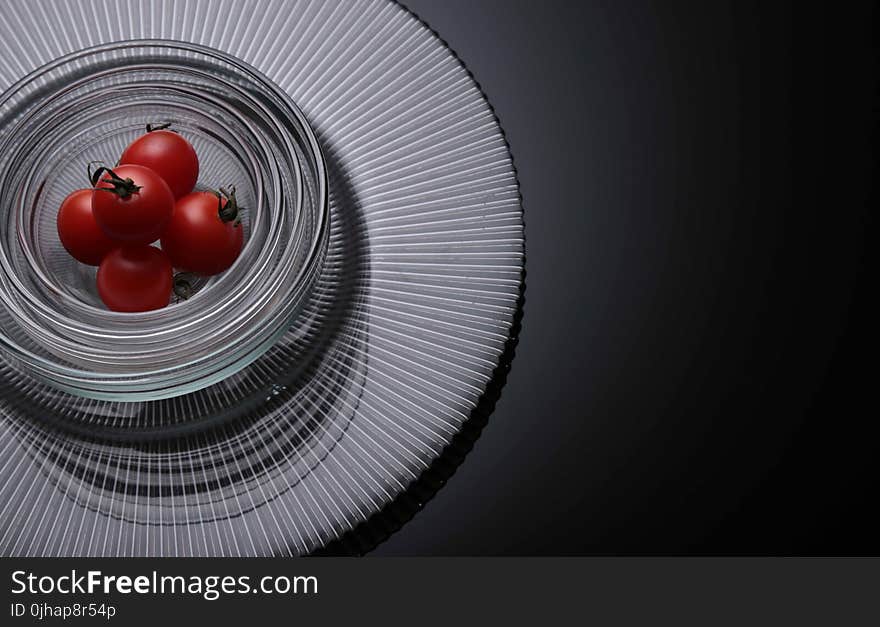 Five Tomatoes on Clear Glass Bowls